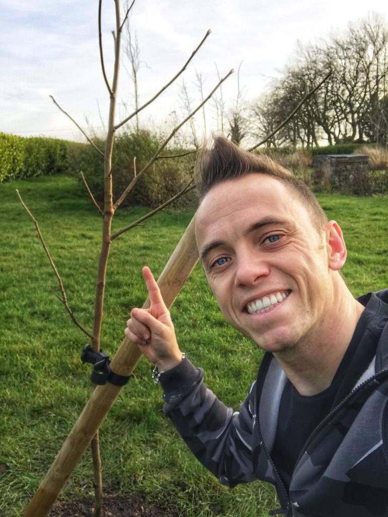 Garden Ninja next to a newly planted tree