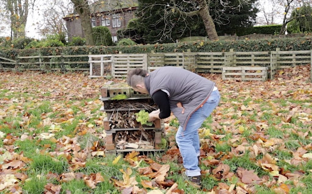 Garden ninja filling a bug hotel