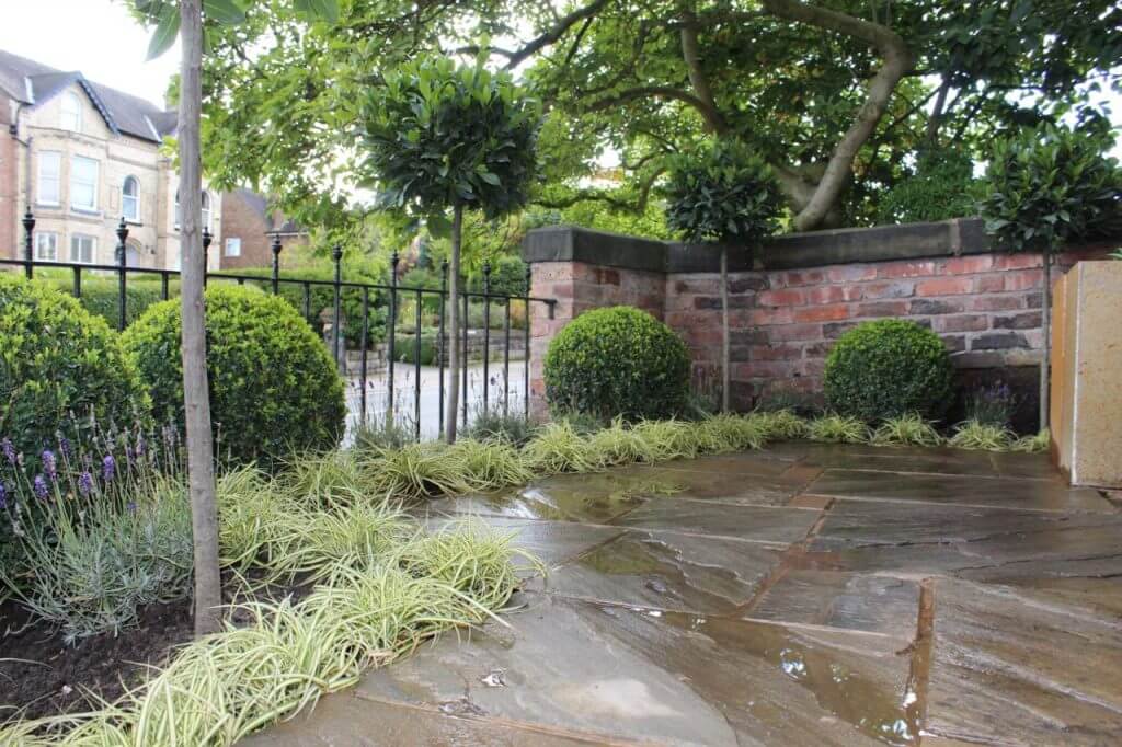 A yorkstone terrace and formal planting by Garden Ninja Lee Burkhill