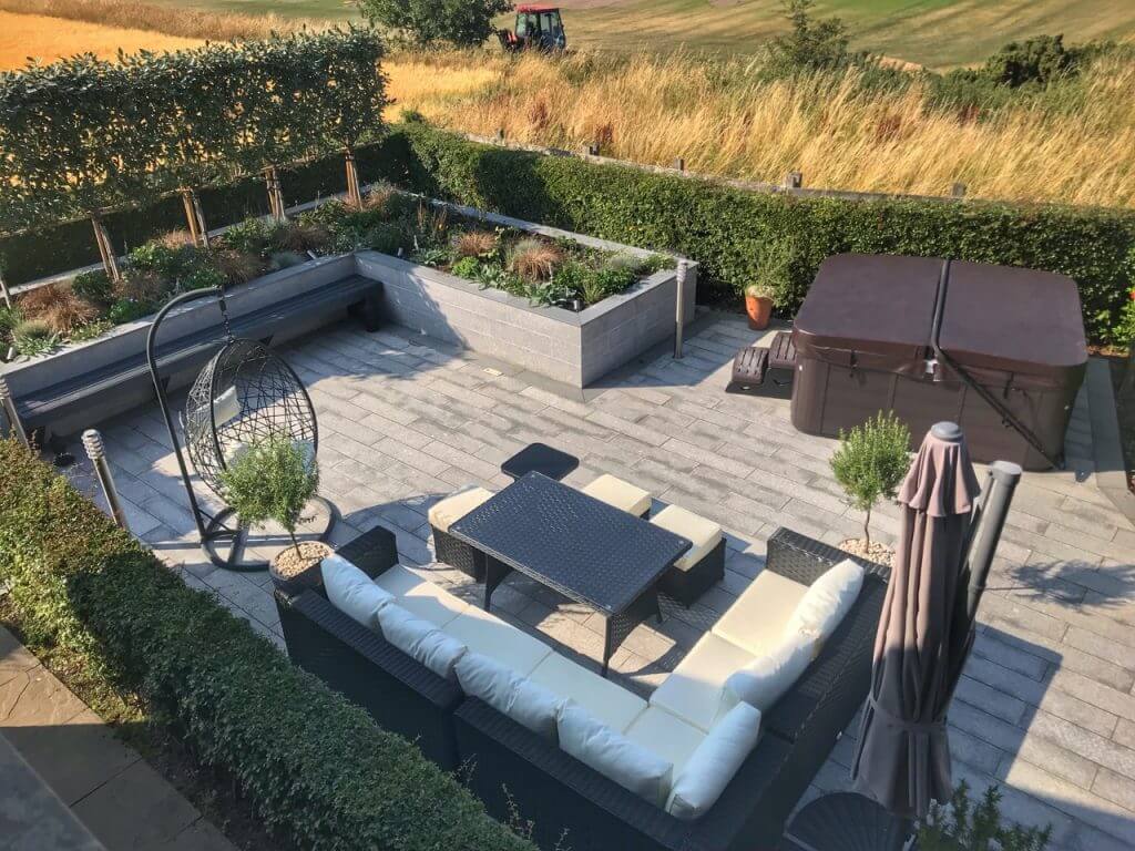 Modern outdoor garden with seating area raised beds and hot tub