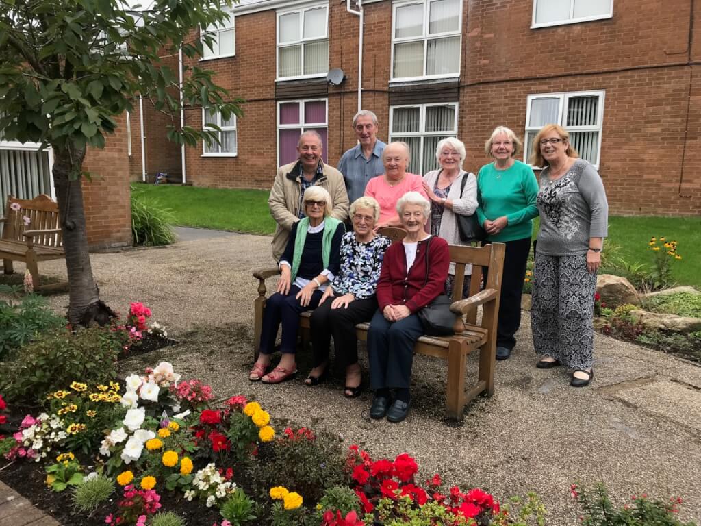 Community garden residents sat on a bench