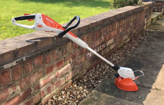 A Stihl strimmer against a wall