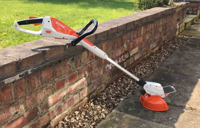 A Stihl strimmer against a wall