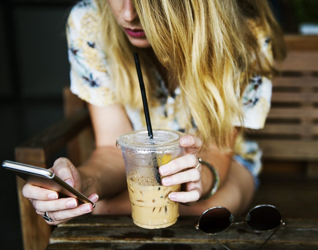 A girl drinking a iced coffee