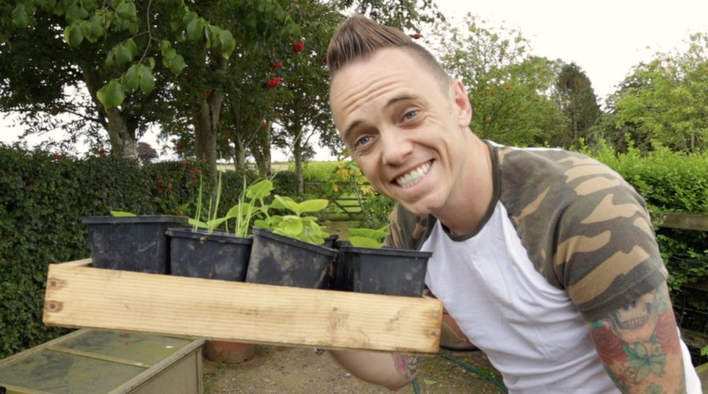 Garden Ninja with a seed tray full of plants