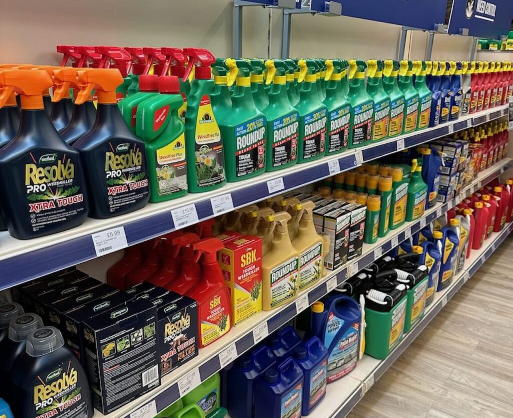 A shelf full of weed killers in a garden centre